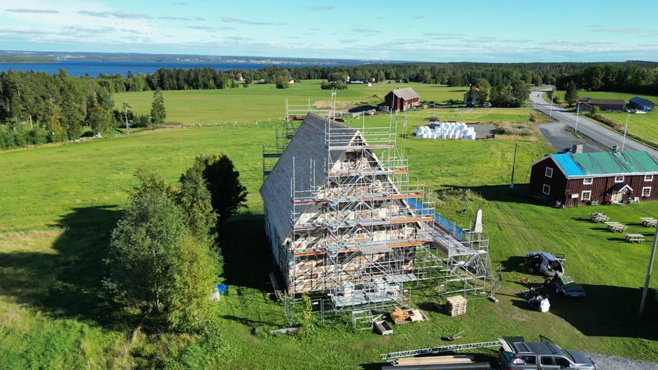 Ställning runt ett högt vattentorn, sedd från luften över skogen
